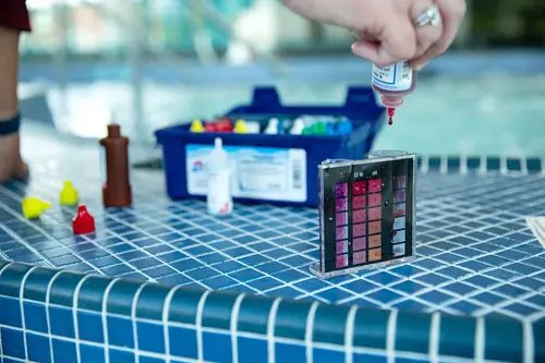 Testing water with a Taylor Test Kit.